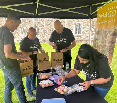 A group of volunteers setting up a cake sale